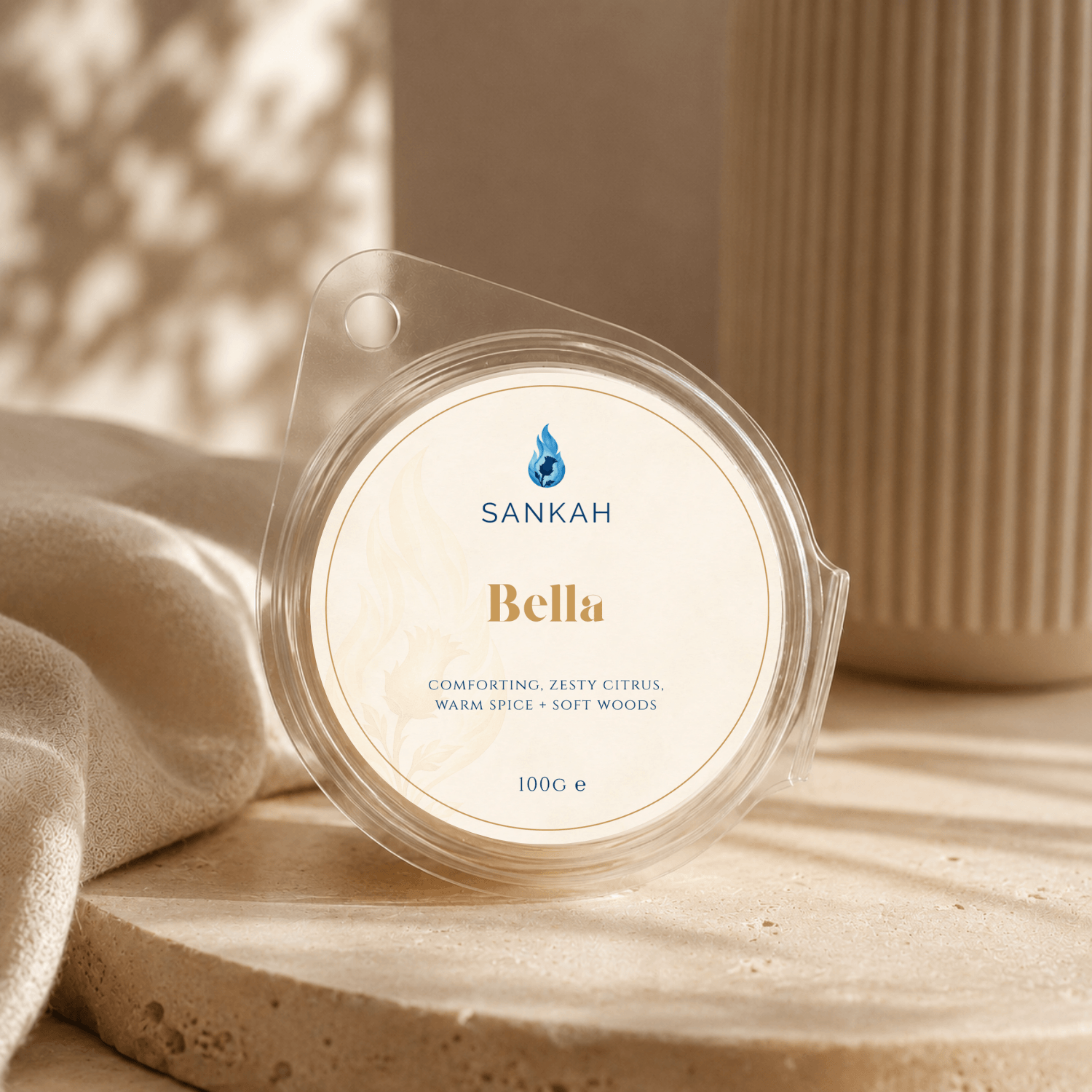 Sankah Bella wax melt packaging on a textured surface with a blurred background